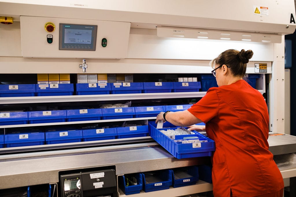 operator using vertical carousel in hospital pharmacy