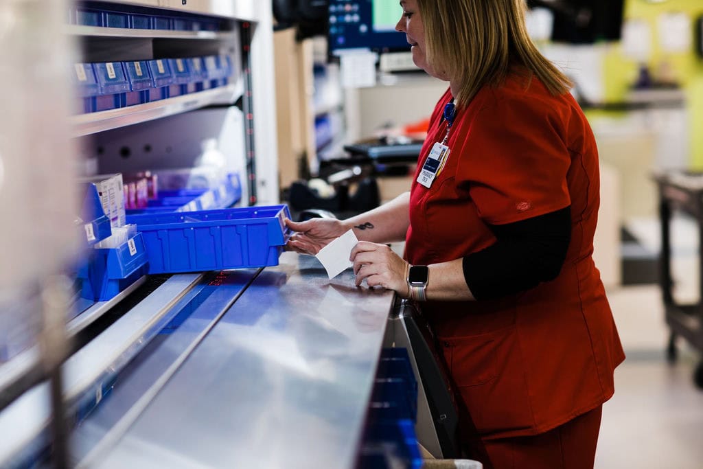 operator using vertical carousel in hospital pharmacy