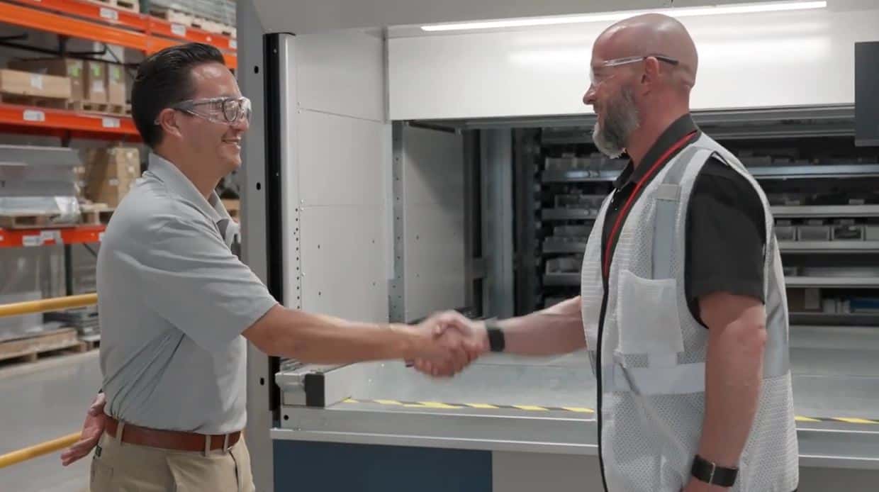 Dustin Walker shakes hands with ABB manager in VLM case study