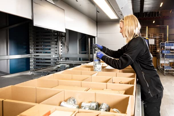 a woman picking parts from a vlm